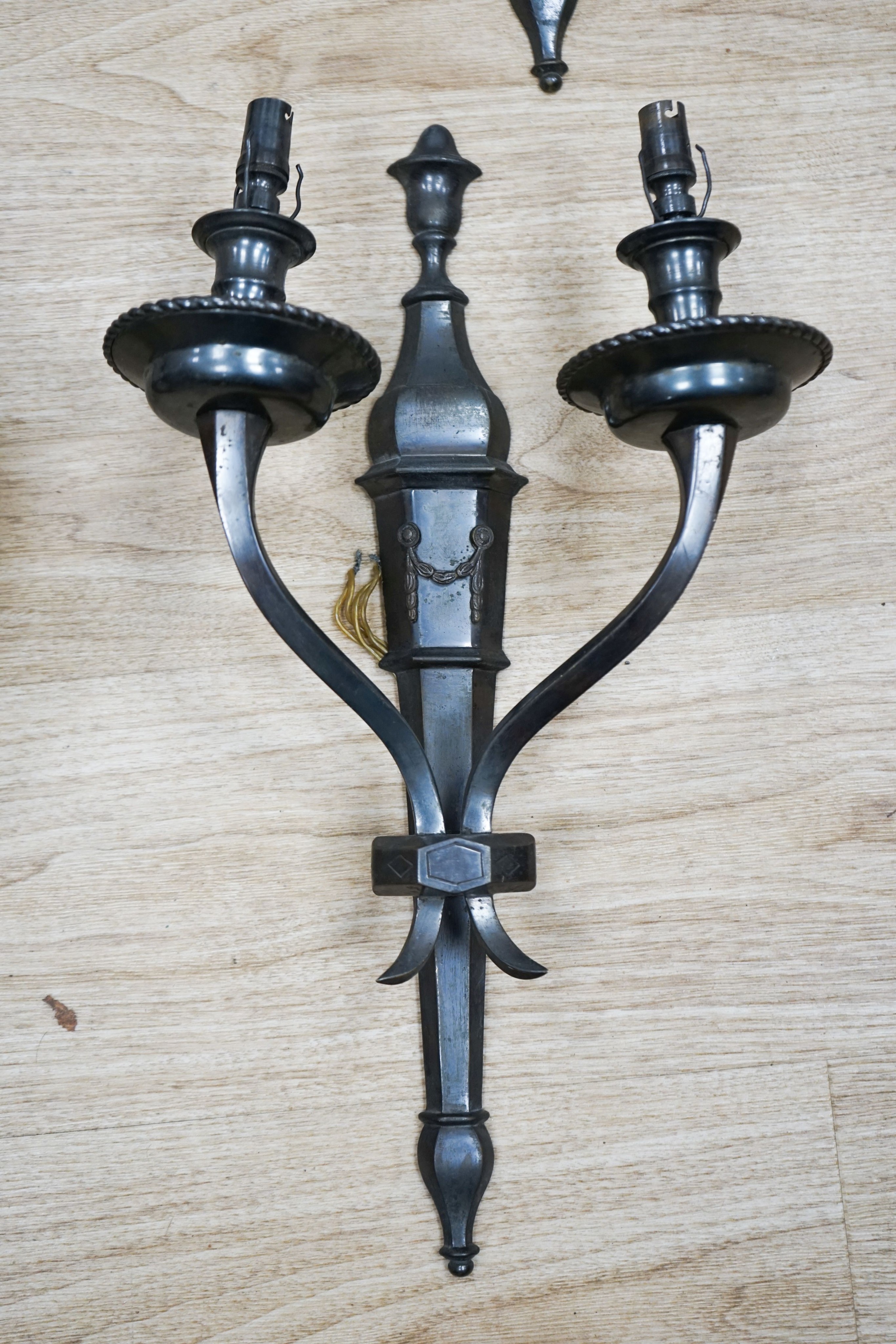 A set of four patinated brass wall lights 48cm